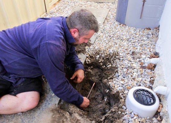 plumber fixing an underground hot water pipe leaking